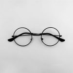 black framed eyeglasses on white surface